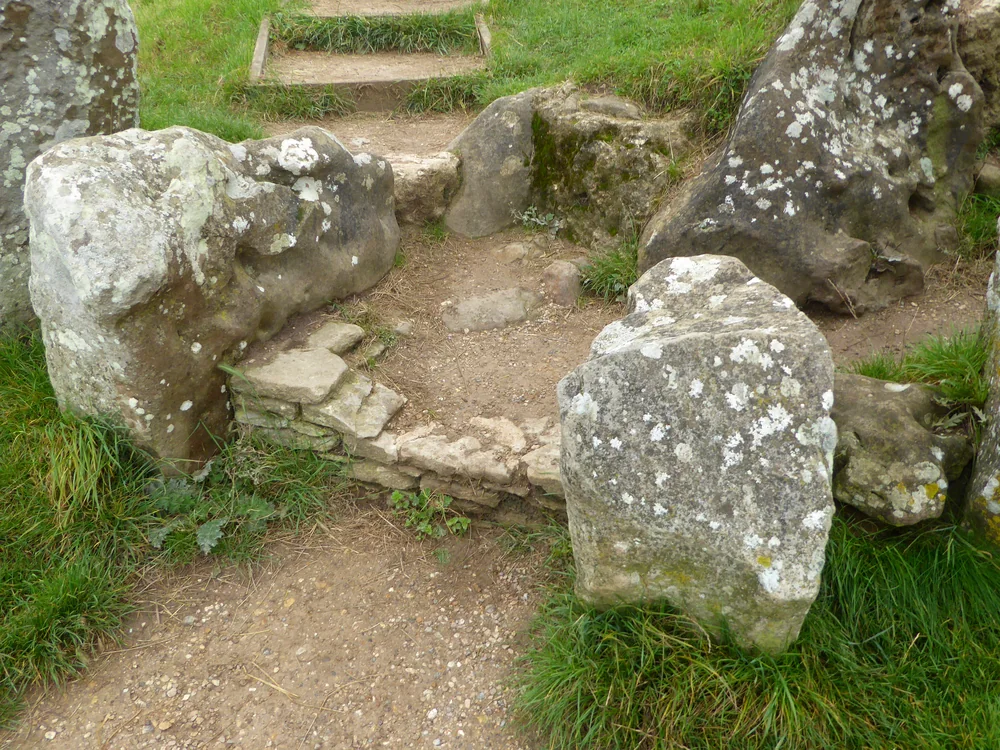 Large lichen-covered sarsen stones forming the entrance to the burial chambers at West Kennet Long Barrow